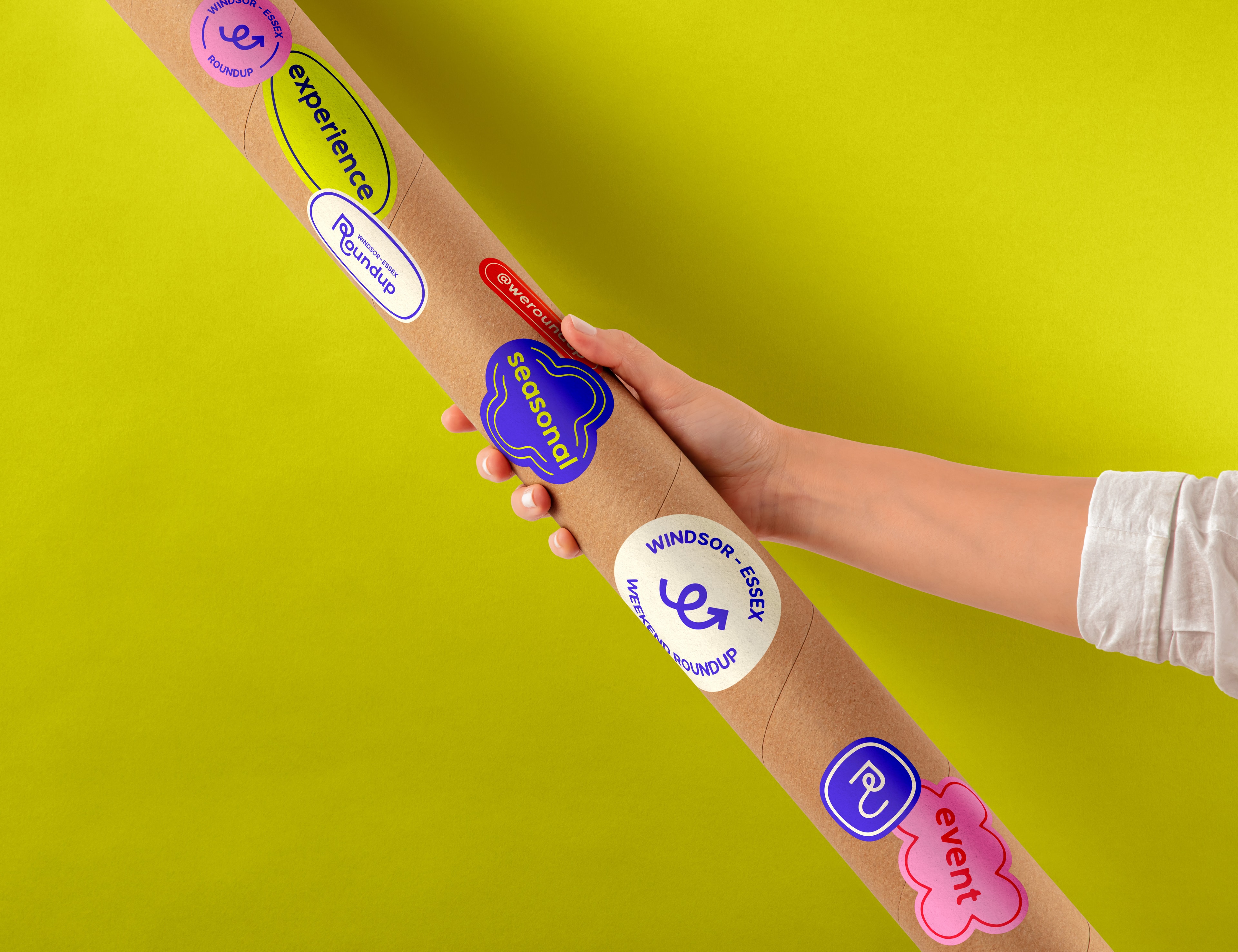 A person holding a roll of posters